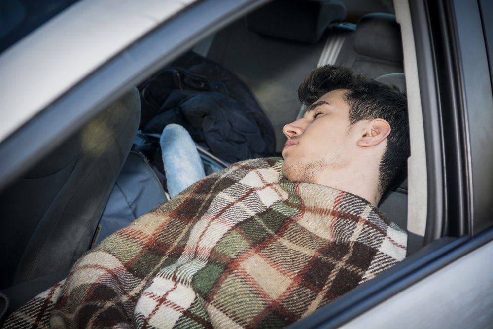 sleeping inside his car