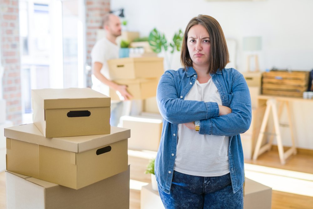 couple arround cardboard boxes moving