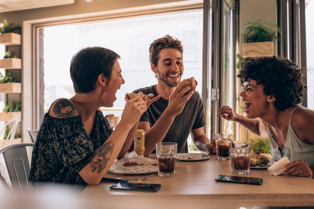 friends having burger at restaurant