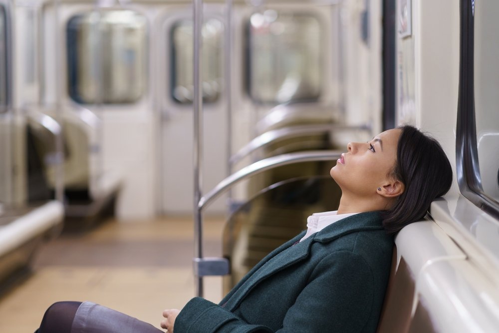 woman relaxing resting on seat in subway train