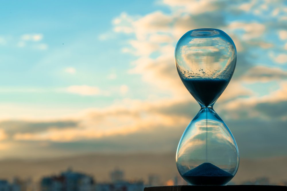 Hourglass and city at sunset