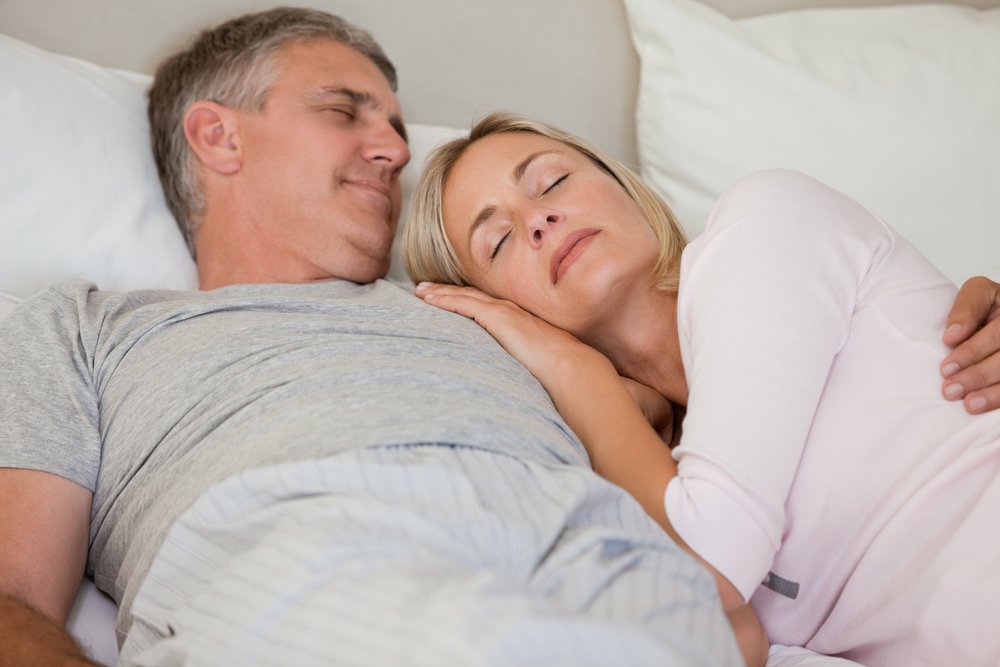 couple sleeping on their bed