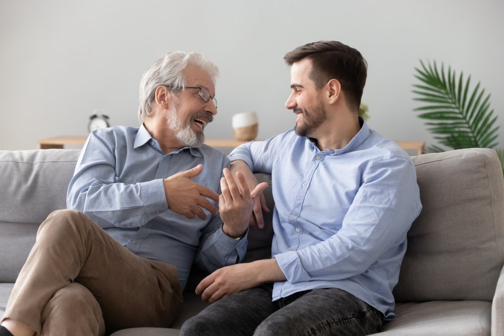 friendly positive conversation sit on sofa at home